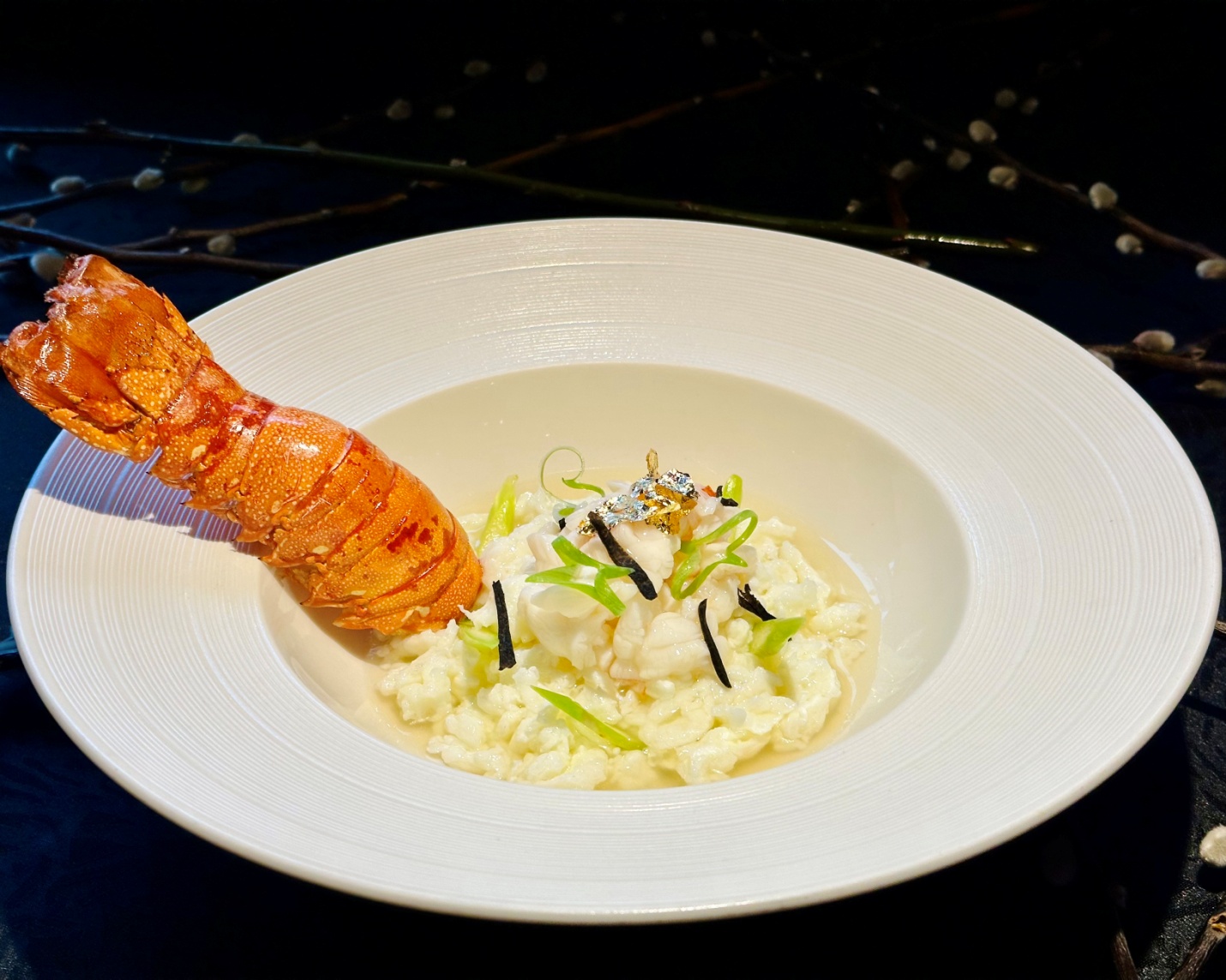 C:\Users\GCPI-ROBBY\Desktop\PRS\WHIMSICAL SELECTIONS AT TEA OF SPRING\Main Course 2- Poached Lobster and Seafood, Perigord Black Truffle, Egg White Curd, Master Broth, Asparagus, Gold Leaves.png