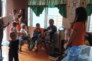 A group of people in a room Description automatically generated