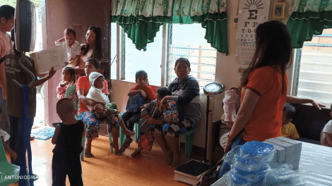 A group of people in a room Description automatically generated