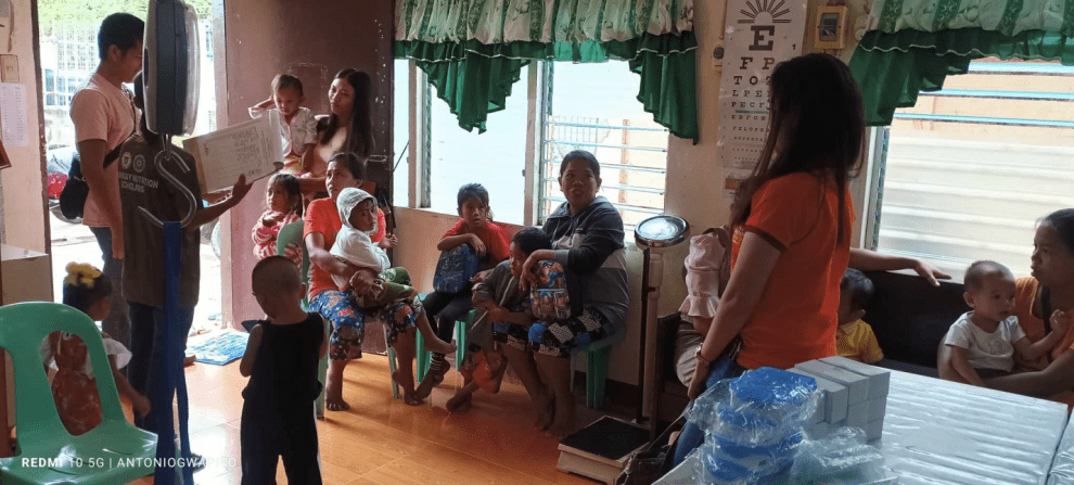 A group of people in a room Description automatically generated