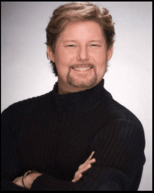 A person in a black sweater Description automatically generated