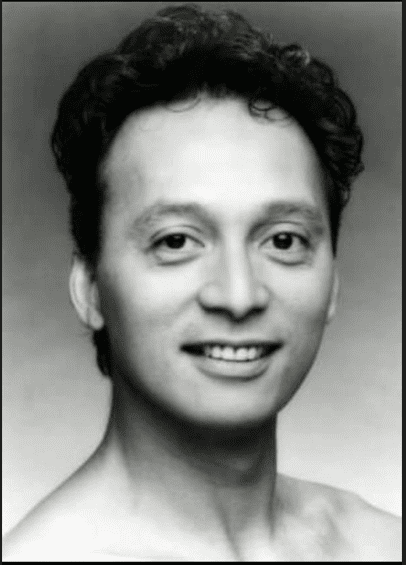 A person smiling at the camera Description automatically generated