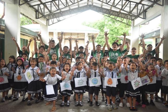 A group of children holding their hands up AI-generated content may be incorrect.