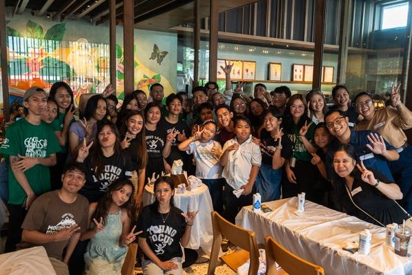 A group of people posing for a photo AI-generated content may be incorrect.