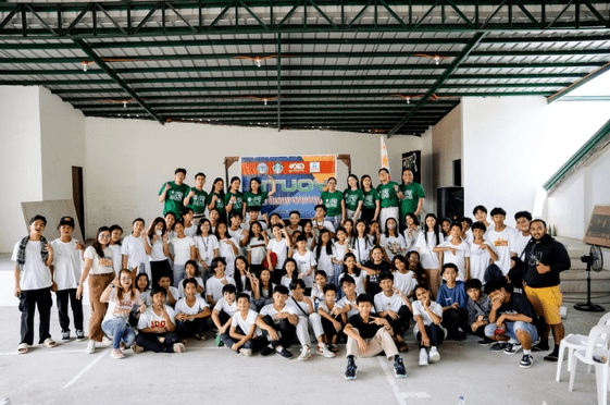 A group of people posing for a photo AI-generated content may be incorrect.