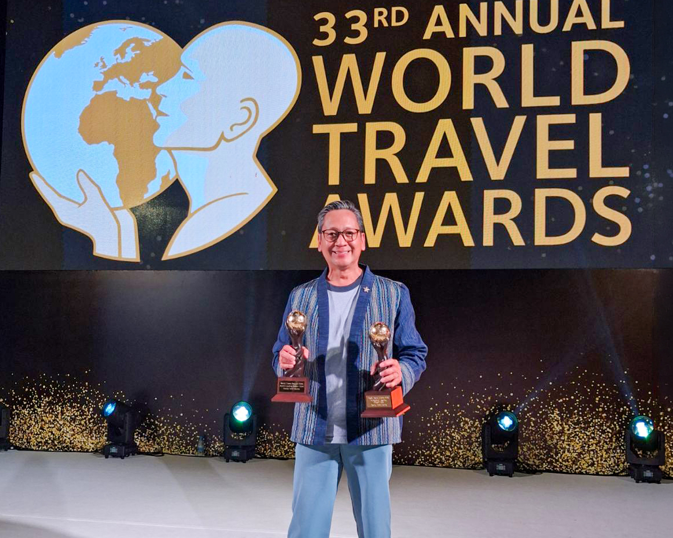 General Manager Den Navarro holds Savoy Hotel Manila’s two World Travel Awards—Asia’s Leading Airport Hotel and Philippines’ Leading Airport Hotel—on behalf of the hotel and its entire team